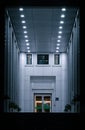 A close-up shot of the extended line view of the open modern building corridor at night Royalty Free Stock Photo