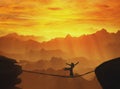 Highline walker silhouette in mountains at sunset . Royalty Free Stock Photo