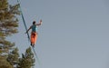 Highliner walks on a tightrope against the backdrop of the sky