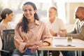 Highly driven, eager and open. Portrait of a young businesswoman at the office sitting in front of her colleagues having