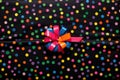 highly magnified multi-colored polka dots on a black gift wrap