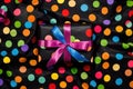 highly magnified multi-colored polka dots on a black gift wrap