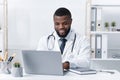 Highly qualified black doctor consultating patients online