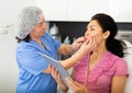 Experienced cosmetology doctor in the clinic does a mechanical facial cleaning a young female client