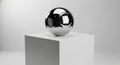 A highly reflective chrome sphere sits atop a plain white cube pedestal. The sphere\'s Royalty Free Stock Photo