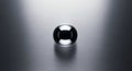 A highly reflective metallic sphere is placed on a brushed aluminum surface. The sphere has a Royalty Free Stock Photo