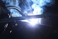 A highly skilled welder welds a metal structure at an assembly plant