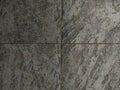 Highresolution image of dark gray stone tiles with a textured, natural look. Perfect for backgrounds, website designs, or