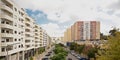 Highrise apartment buildings along alane with trafic in Lisbon