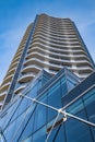 A highrise building against the blue sky. Condominium or apartment building. Looking Up Blue Modern Building Royalty Free Stock Photo