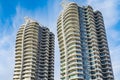 A highrise building against the blue sky. Condominium or apartment building. Looking Up Modern Building