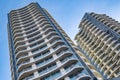 A highrise building against the blue sky. Condominium or apartment building. Looking Up Blue Modern Building