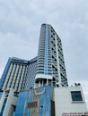 Blue modern luxury glass building low angle on a cloudy sky. Muong Thanh Hotel in Quang Ninh, Vietnam Royalty Free Stock Photo