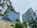 Blue modern luxury glass building low angle on a cloudy sky. Muong Thanh Hotel in Quang Ninh, Vietnam Royalty Free Stock Photo