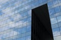 Highrise glass building with sky and clouds reflection. geometric shapes Royalty Free Stock Photo