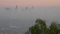 Highrise skyscrapers of metropolis in smog, Los Angeles, California USA. Air toxic pollution and misty urban downtown skyline. Royalty Free Stock Photo