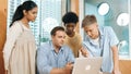 Highschool boy presenting project while teacher looking at laptop. Edification. Royalty Free Stock Photo