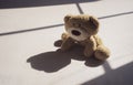 Hight key light Sad teddy bear sitting alone on white background with shadow.Lonely concept, International missing children`s day