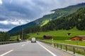 Highway along green fields and mountains in Switzerland. Royalty Free Stock Photo