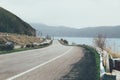 Highway with a background of lake and mountains