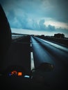 Highway bike ride at evening time during monsoon season with rainy and cloudy weather Royalty Free Stock Photo