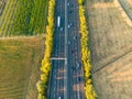 Highway from a bird\'s eye view. As the sun goes down, the sun\'s rays create beautiful long shadows on the ground.
