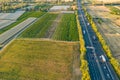 Highway from a bird\'s eye view. As the sun goes down, the sun\'s rays create beautiful long shadows on the ground.