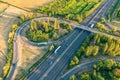 Highway from a bird\'s eye view. As the sun goes down, the sun\'s rays create beautiful long shadows on the ground.