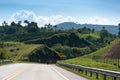 Highway in tropical climate surrounded by mountains with forest. Colombia