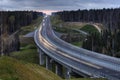 A highway crosses the Russian forest at night.