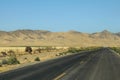 Highway crossing a mountainous and desert area of California, US Royalty Free Stock Photo