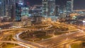 Highway crossroad and office buildings in Dubai Internet City and Media City district aerial night timelapse