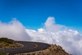 Highway curve above fluffy white clouds and blue sky Royalty Free Stock Photo
