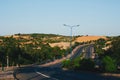 Highway curve road overpass nature landscape background dark tone mist day time street tall lanterns trees bushes Royalty Free Stock Photo