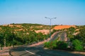 Highway curve road overpass nature landscape background dark tone mist day time street tall lanterns trees bushes Royalty Free Stock Photo