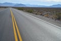 Highway in Death Valley desert blue mountain range Royalty Free Stock Photo