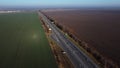 Highway driving passing cars fields green agricultural crops plowed black soil