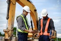 Highway Engineer Consultant and Young engineer planning work together with a technology tablet at the road construction site.