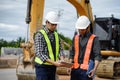 Highway Engineer Consultant and Young engineer planning work together with a technology tablet at the road construction site.