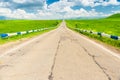 Highway, green field and beautiful clouds on a sunny day Royalty Free Stock Photo