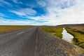 Highway through Icelandic landscape under a blue summer sky with Royalty Free Stock Photo