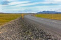 Highway through Icelandic landscape under a blue summer sky Royalty Free Stock Photo