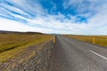 Highway through Icelandic landscape under a blue summer sky with Royalty Free Stock Photo