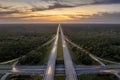 Highway intersection in Florida rural area at sunset. Elevated interchange lanes for express passing of car traffic Royalty Free Stock Photo