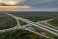 Highway intersection in Florida rural area at sunset. Elevated interchange lanes for express passing of car traffic Royalty Free Stock Photo