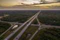 Highway intersection in Florida rural area at sunset. Elevated interchange lanes for express passing of car traffic Royalty Free Stock Photo