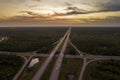 Highway intersection in Florida rural area at sunset. Elevated interchange lanes for express passing of car traffic Royalty Free Stock Photo