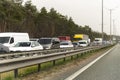 Highway interstate road with car traffic jam and tree forest on background. Motorway bumber barrier gridlock due country