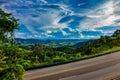 Highway with Landscape of hills with blue sky in the background. Road in mountainous region in Minas Gerais, Brazil