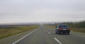 Highway landscape with moving cars at daytime by misty road Royalty Free Stock Photo